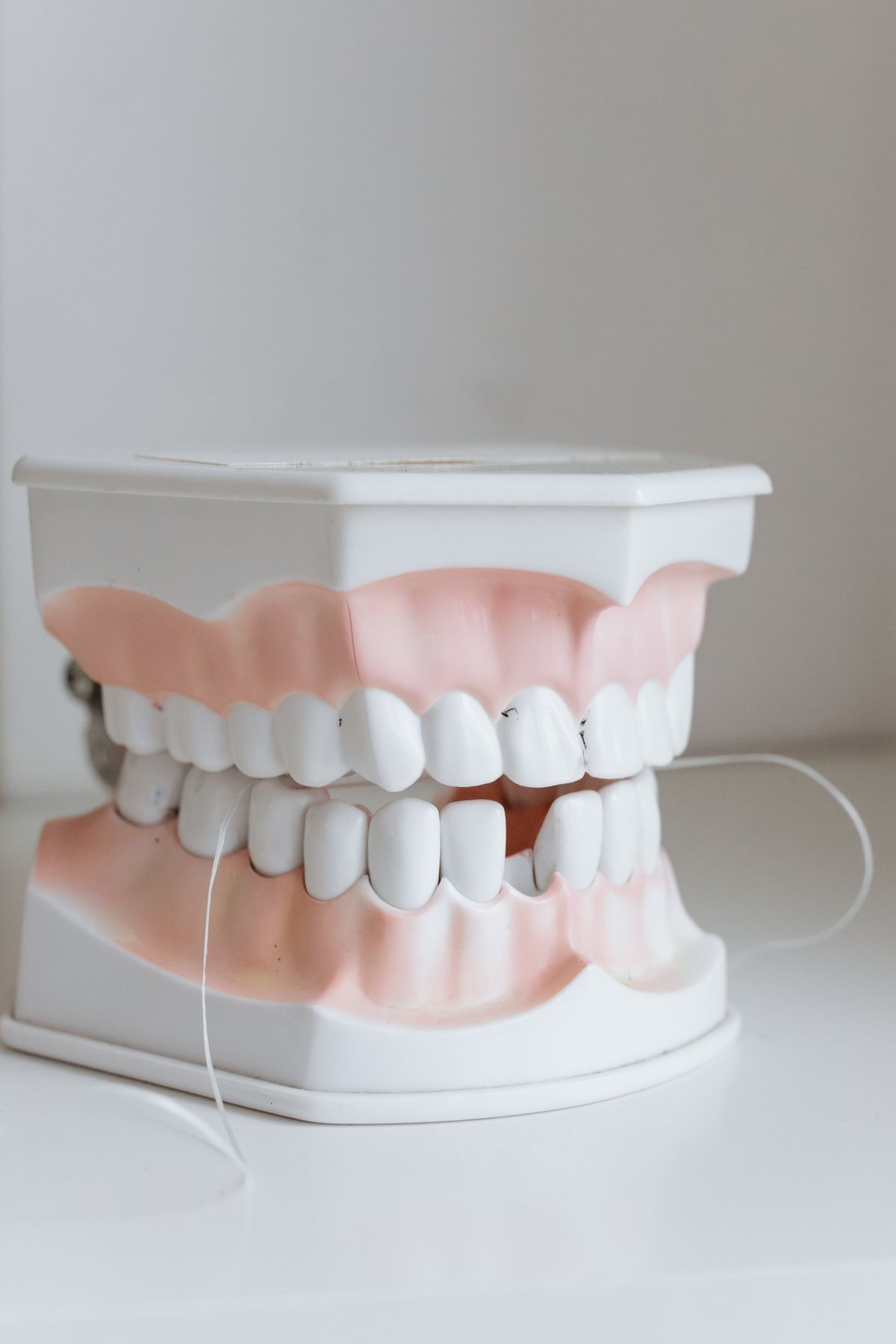 A clean, complete set of natural-looking teeth on a bright background